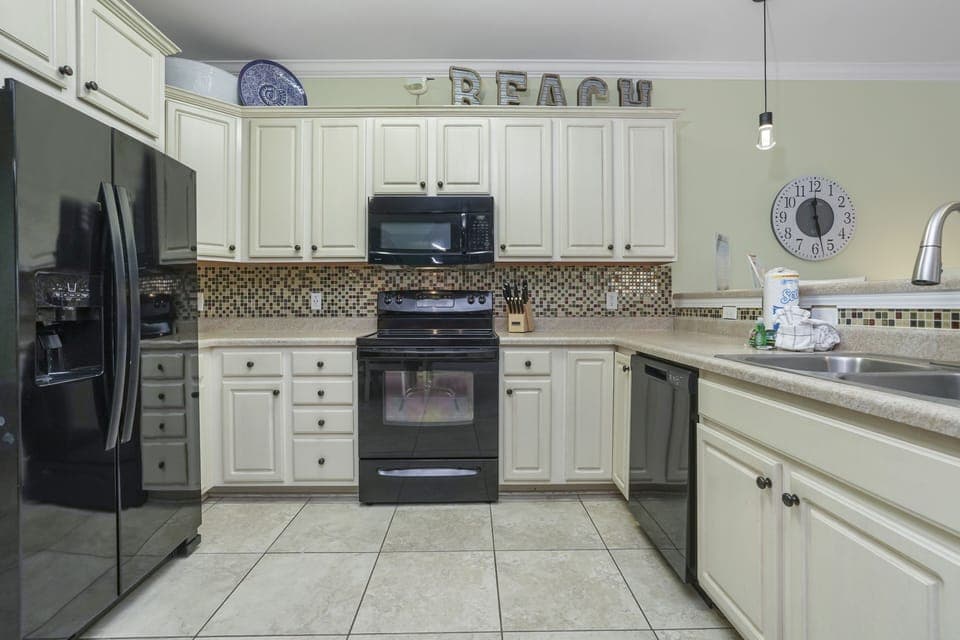 Your fully equipped kitchen invites you to create memorable meals, with modern appliances and coastal charm beckoning you home.