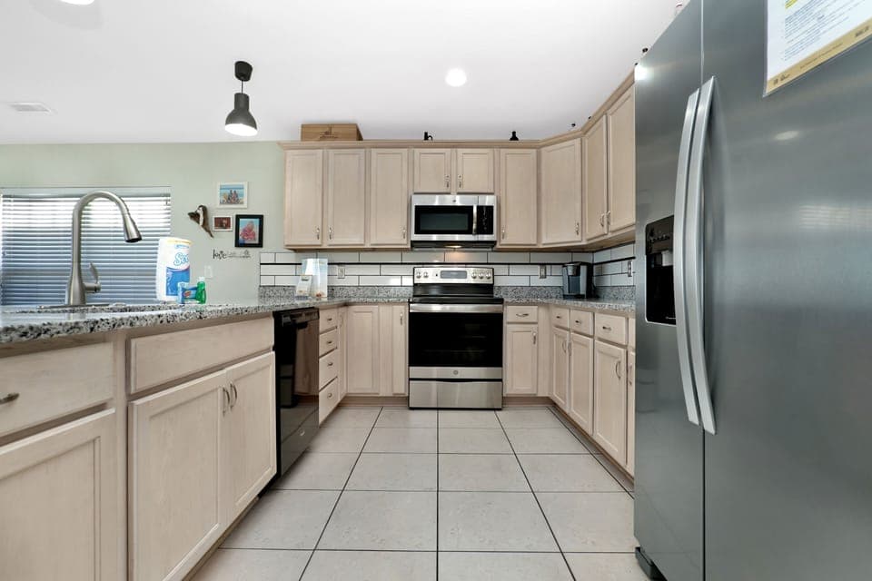 Your spacious kitchen awaits with granite countertops, stainless appliances, and everything you need to create memorable meals together.