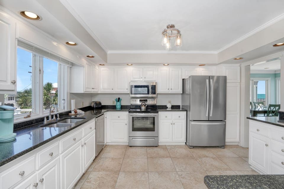 Cook memorable meals in your spacious kitchen with gleaming granite counters, stainless steel appliances, and bright coastal views.