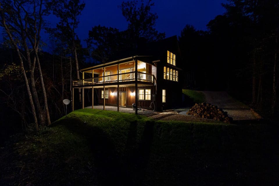 The back of the cabin and upper deck glowing in the night time air.