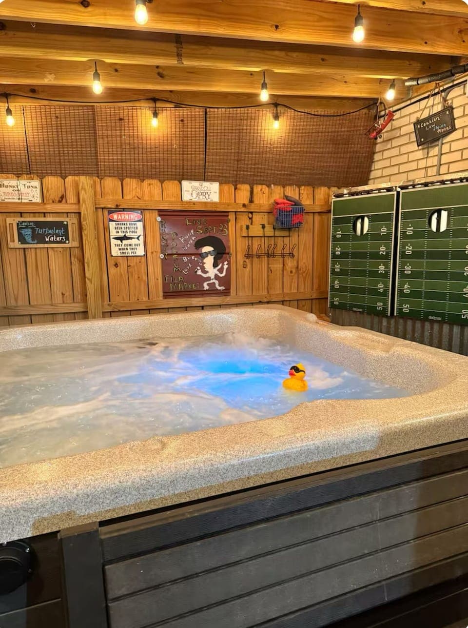 Hot tub jacuzzi with sitting area and bags game for yard