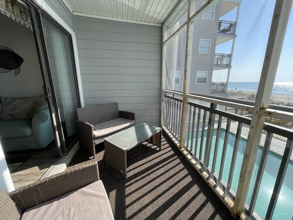 Screen porch with ocean and pool views
