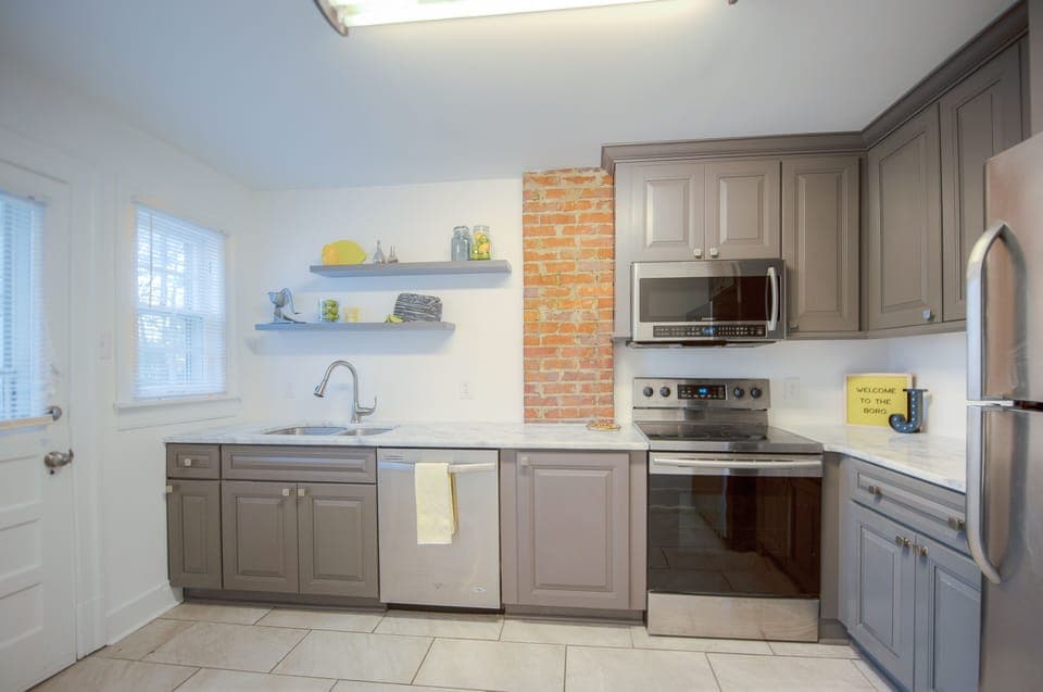 Back door opens to the fully renovated kitchen.