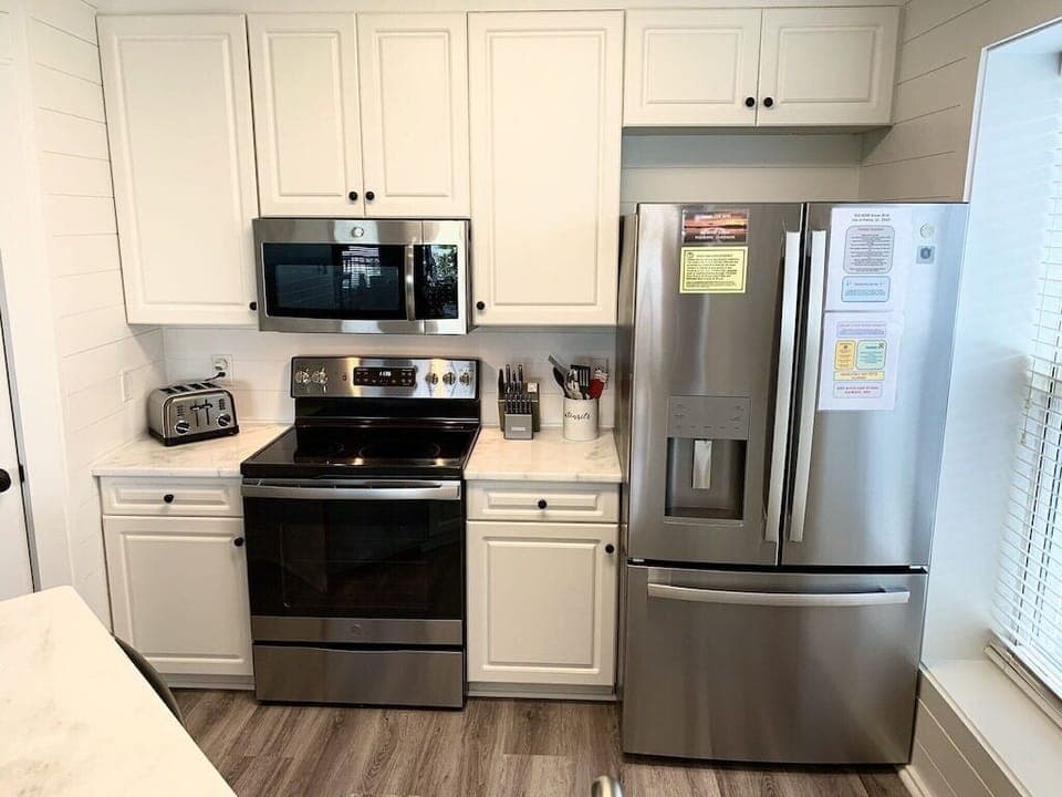 Kitchen with stainless steel appliances. 208 1140 Ocean Blvd, Isle of Palms, SC | IOP Escapes