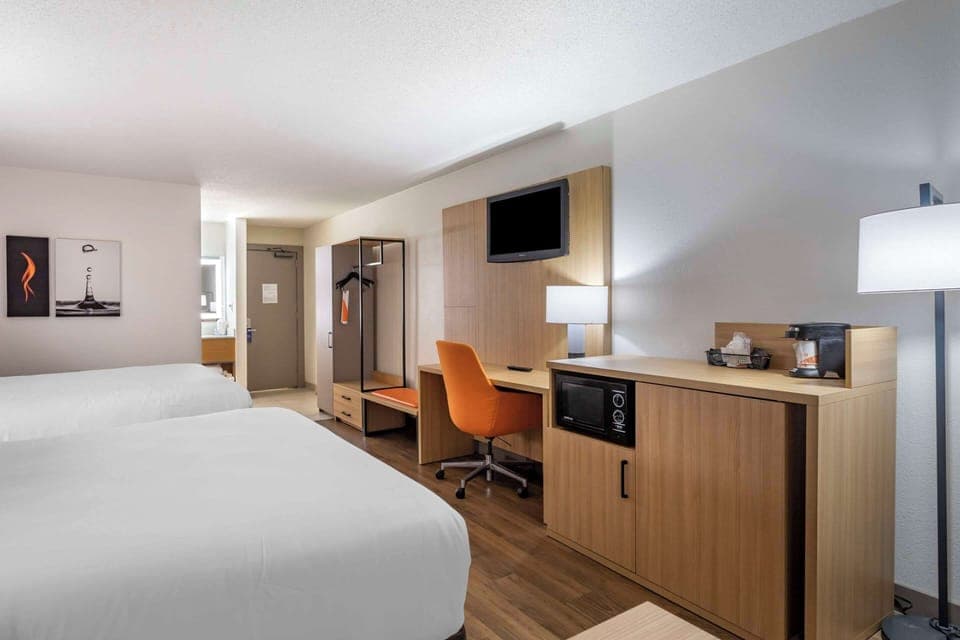 Hypo-allergenic bedding, desk, laptop workspace, blackout drapes