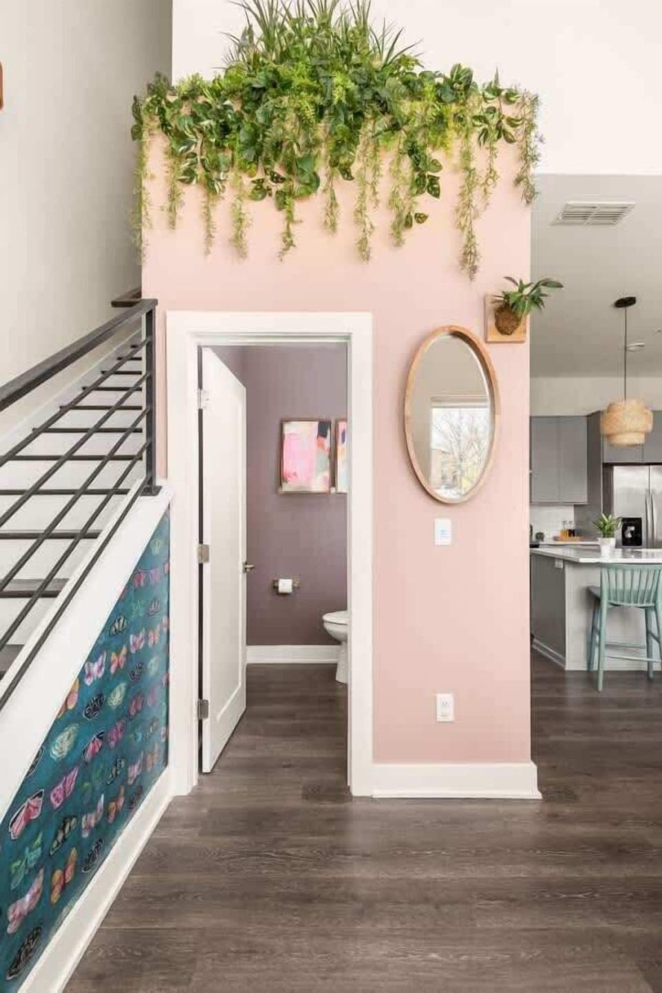 Staircase to upper floor with a half bathroom