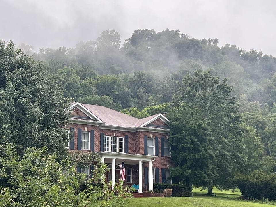 Country Cove on hill top engulfed in clouds.