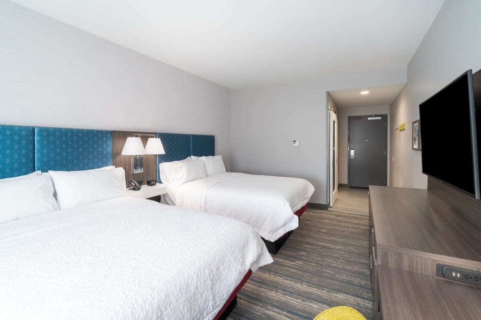 Desk, iron/ironing board, bed sheets