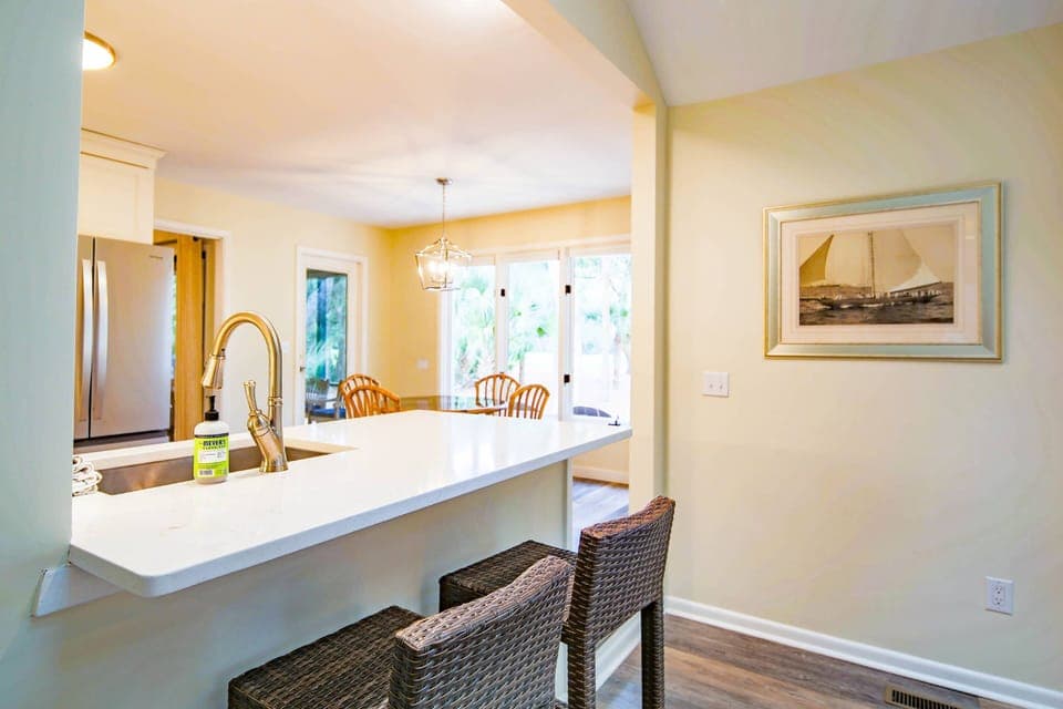 There are two high top stools near the kitchen counter.