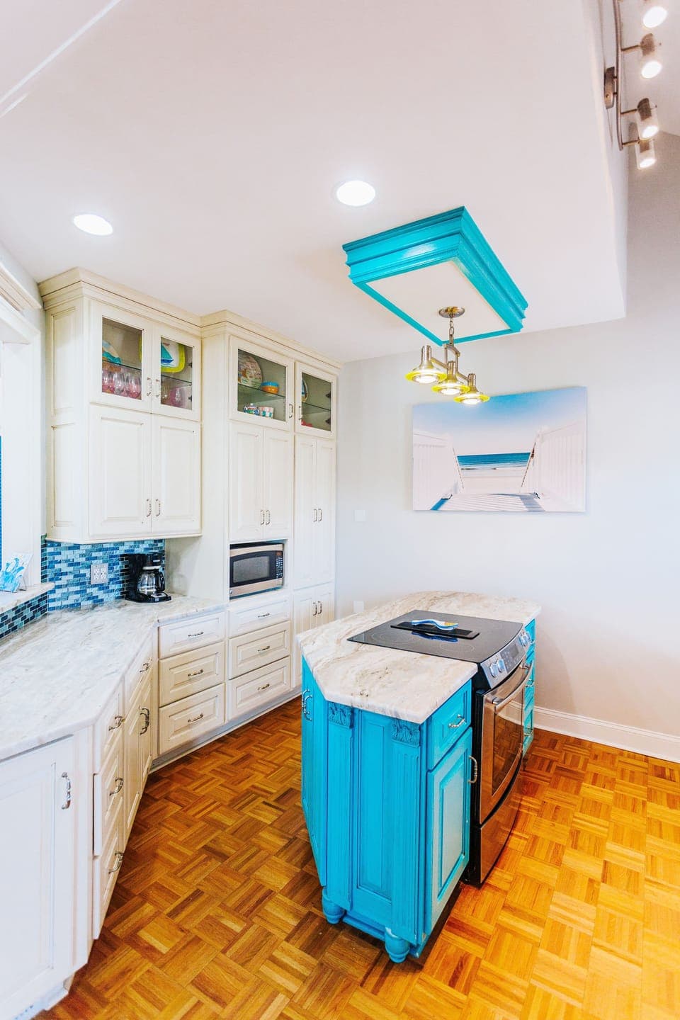 The kitchen is stocked with dishes, silverware, cups, glasses, pots and pans!