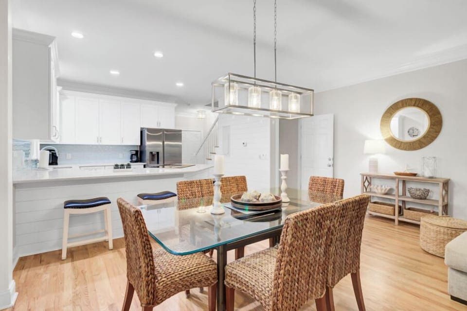 You'll love cooking and dining in this elegant open-concept space with modern appliances and stylish wicker seating for memorable meals.