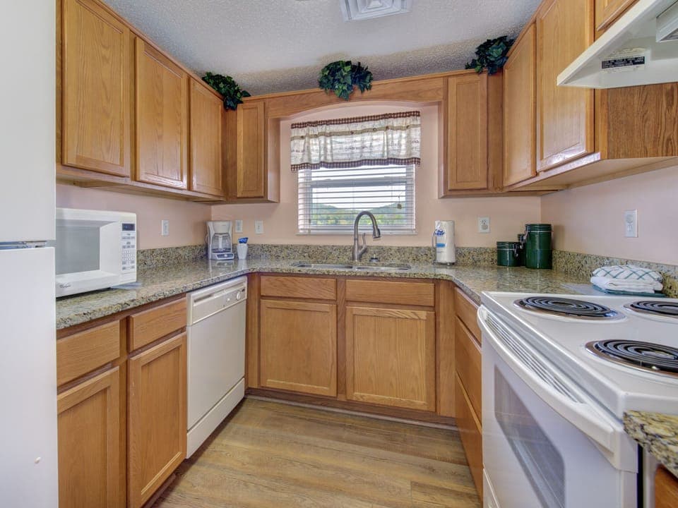 Lots of Counter Space - Compact yet well laid out, the galley kitchen’s granite countertops have plenty of space to get the job done!