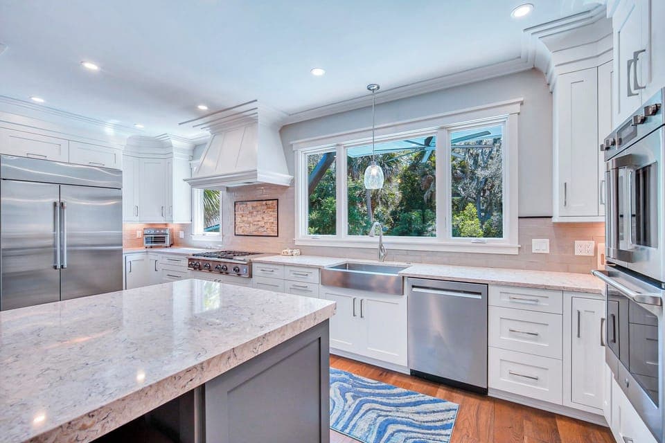 Fully stocked kitchen with stainless steel appliances.