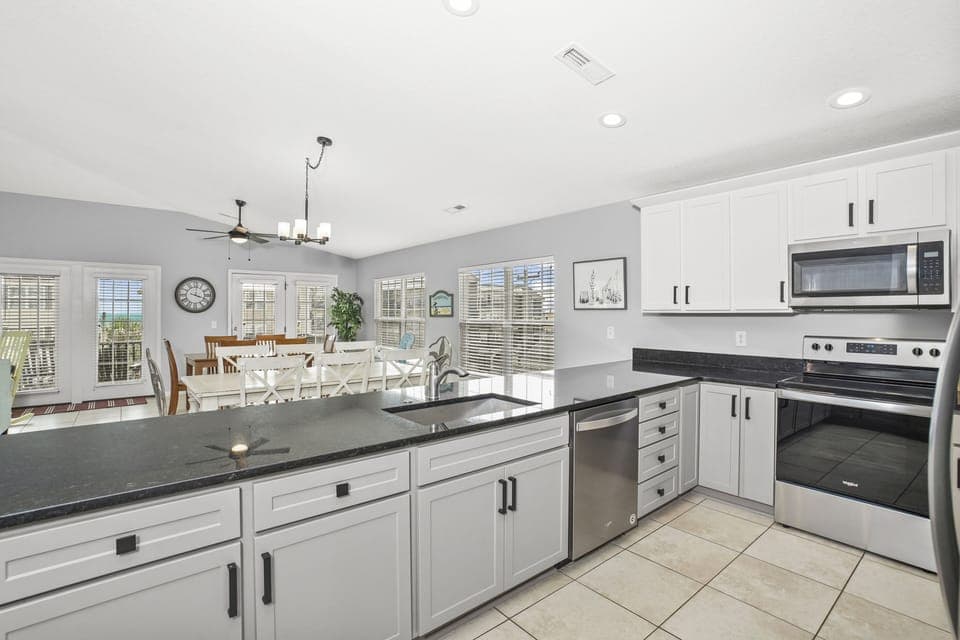 Your spacious kitchen flows into the dining area, featuring granite counters, stainless appliances, and bright windows.