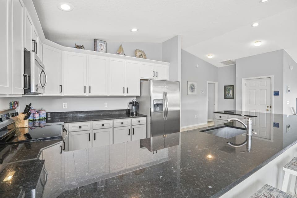 Your gourmet kitchen sparkles with granite counters and stainless steel appliances, perfect for preparing memorable meals during your stay.