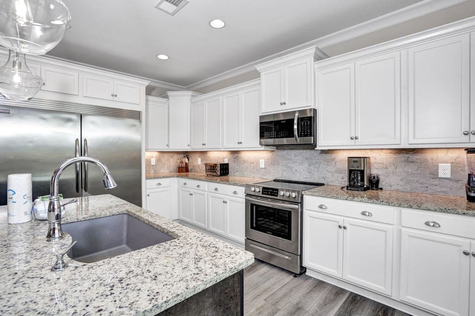Step into your gourmet kitchen with granite counters, stainless appliances, and crisp white cabinets—perfect for creating memorable meals.