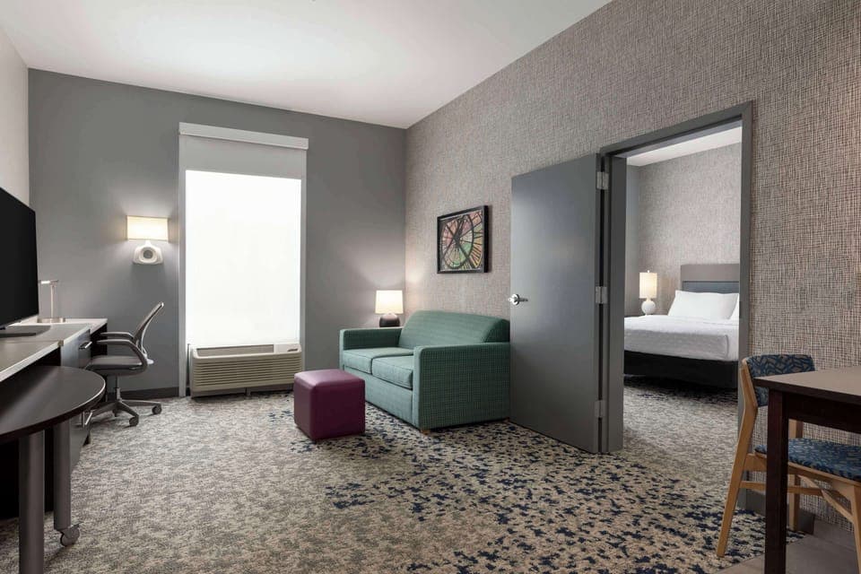 Suite, 1 King Bed | Living area | 42-inch LCD TV with cable channels, TV, MP3 dock