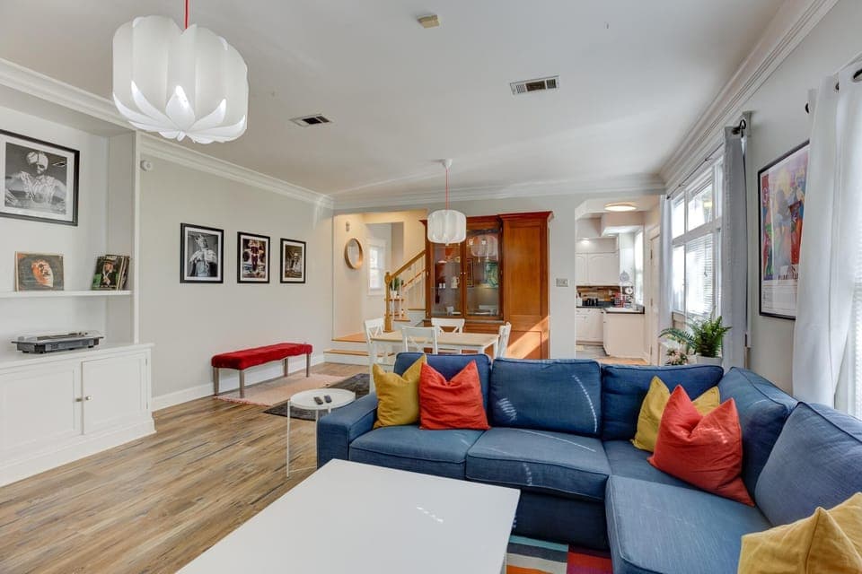 spacious open concept living and dining area with fireplace, sectional, and HDTV