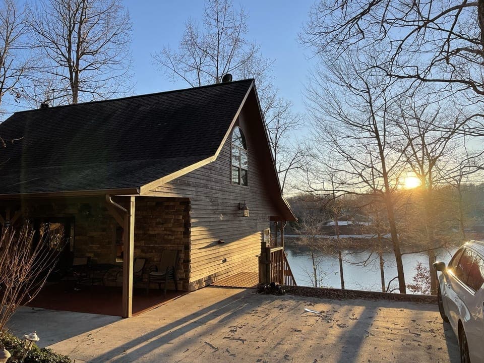 The house with sun setting over main channel of the lake. 
