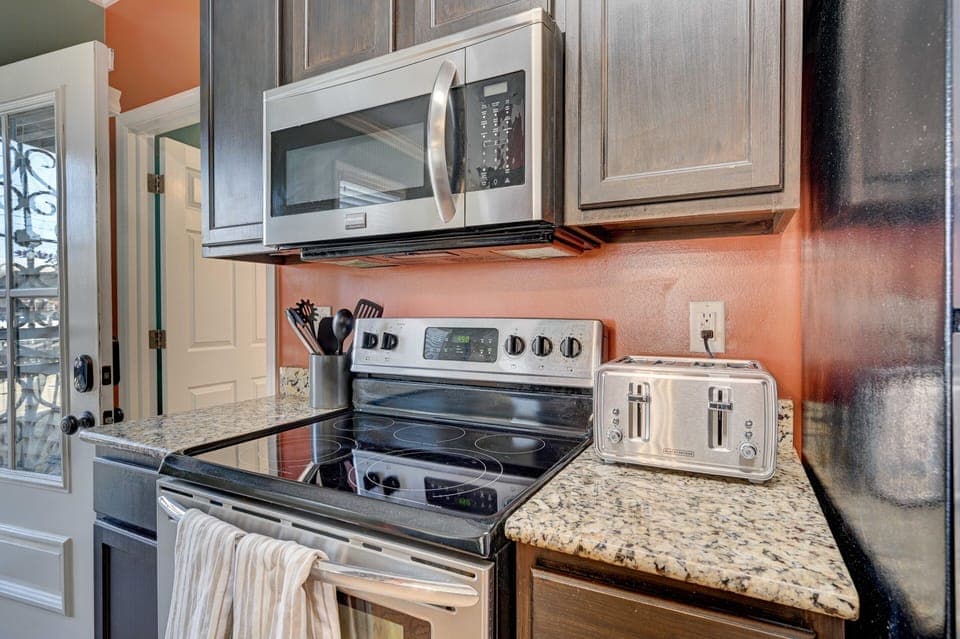 Kitchen including oven/stove, fridge/freezer, and microwave.