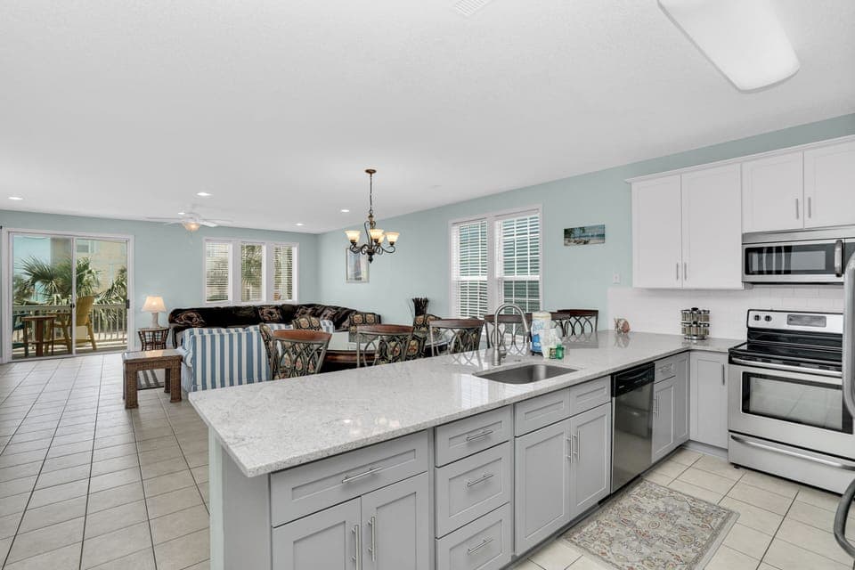 Your fully equipped kitchen flows seamlessly into the living area, perfect for preparing meals while staying connected with family and friends.
