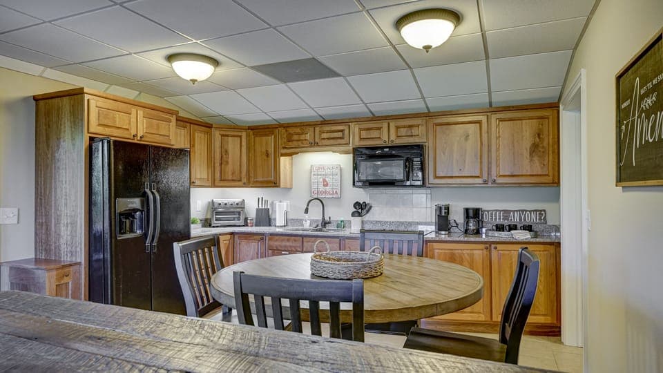 Lower level kitchen with microwave, stove, coffee pot and toaster oven