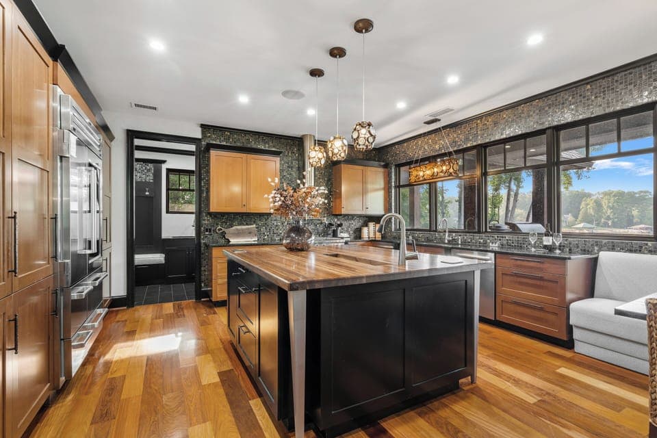 Large kitchen with island, two dishwashers & side by side fridge & freezer.