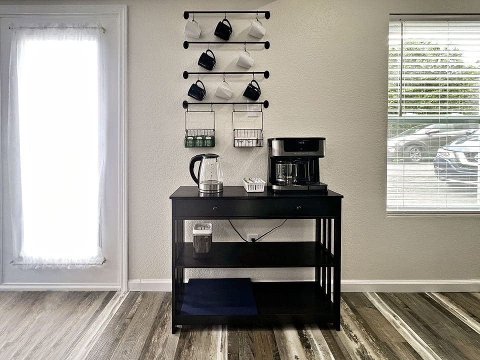 A small coffee bar with coffee pot that will do pods or a full pot.