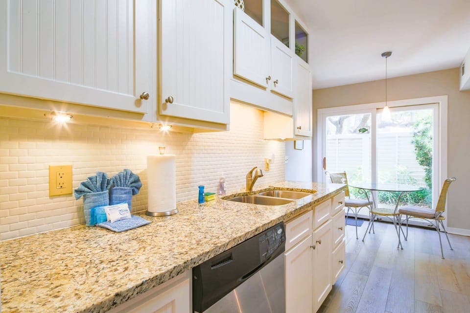 The kitchen also has a dishwasher, sink and dinette table & chairs.