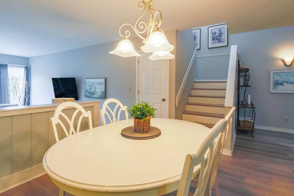 The stairway to the bedrooms on the second floor is located near the dining area.