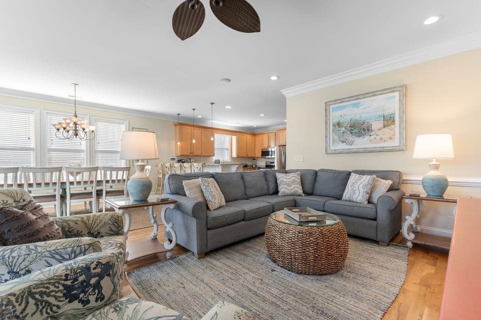 Unwind in your coastal-inspired living space with plush sectional seating, elegant dining area, and fully equipped kitchen—perfect for relaxing evenings together.
