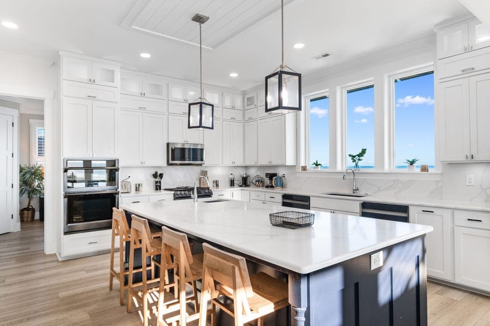 Your gourmet kitchen features pristine white cabinets, marble countertops, and a spacious island perfect for cooking and gathering with loved ones.