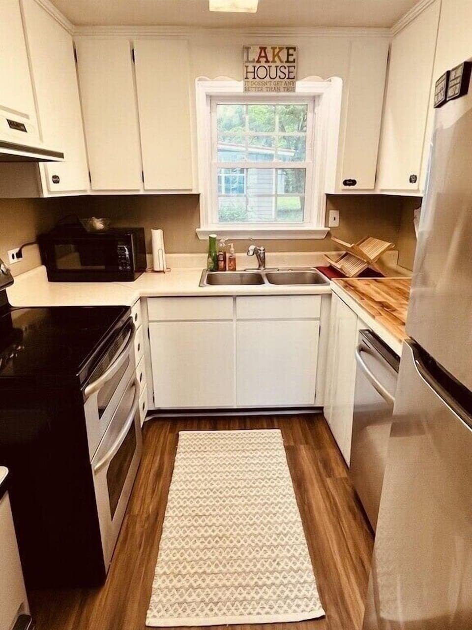 Stocked kitchen features a double oven and butcher block counter space 