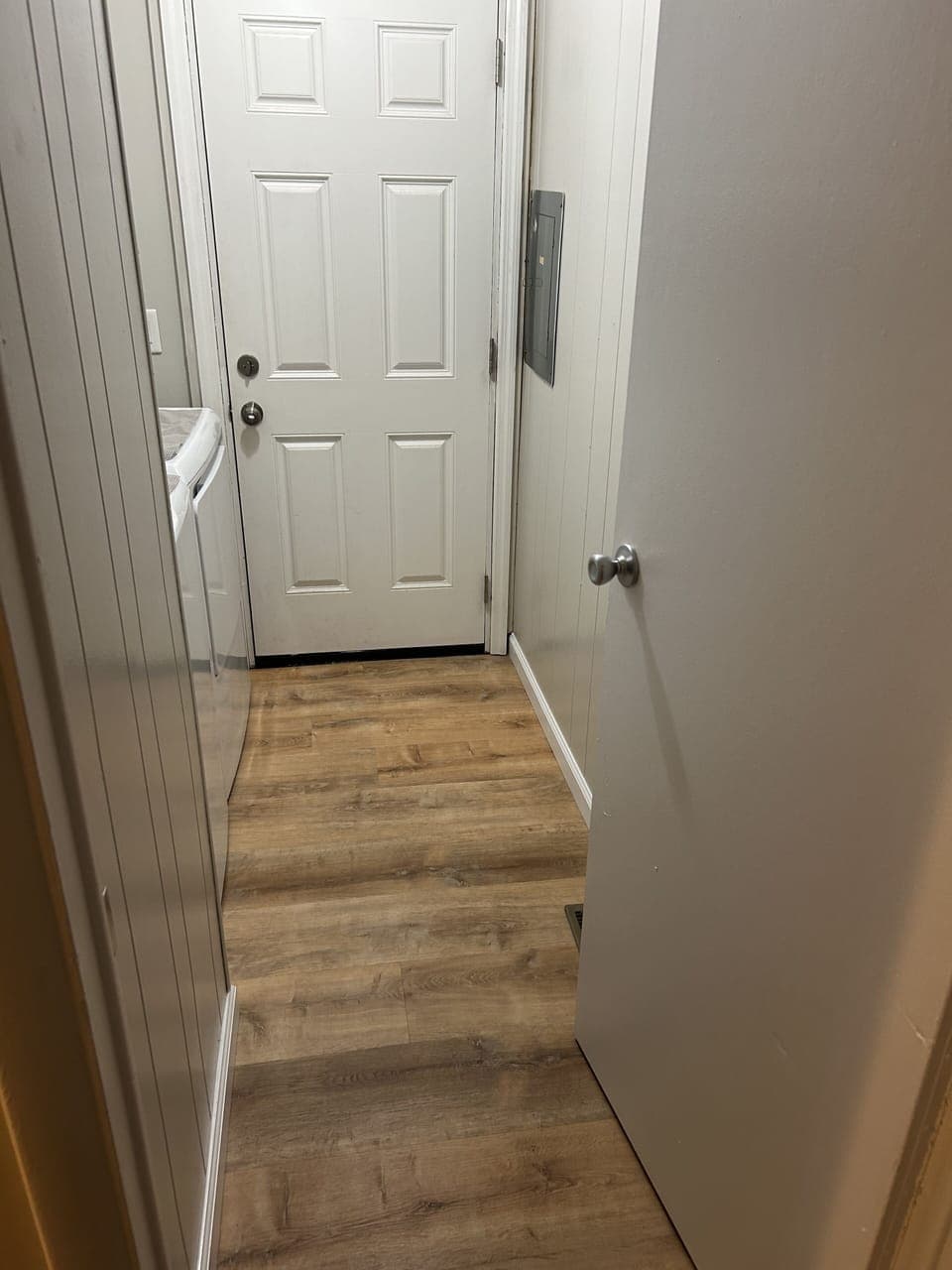 Laundry with rear entrance off driveway.