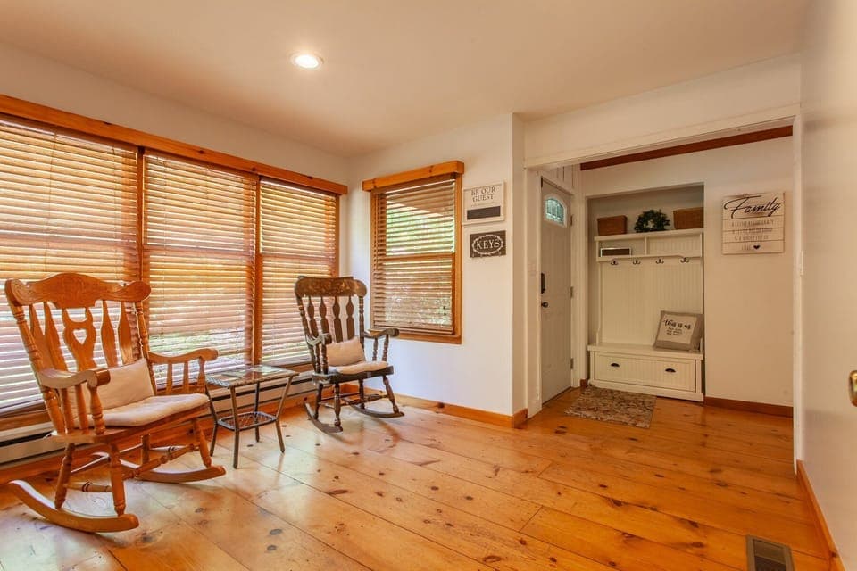 Bright, open-concept floor plan connecting the living area and dining space with hardwood floors.