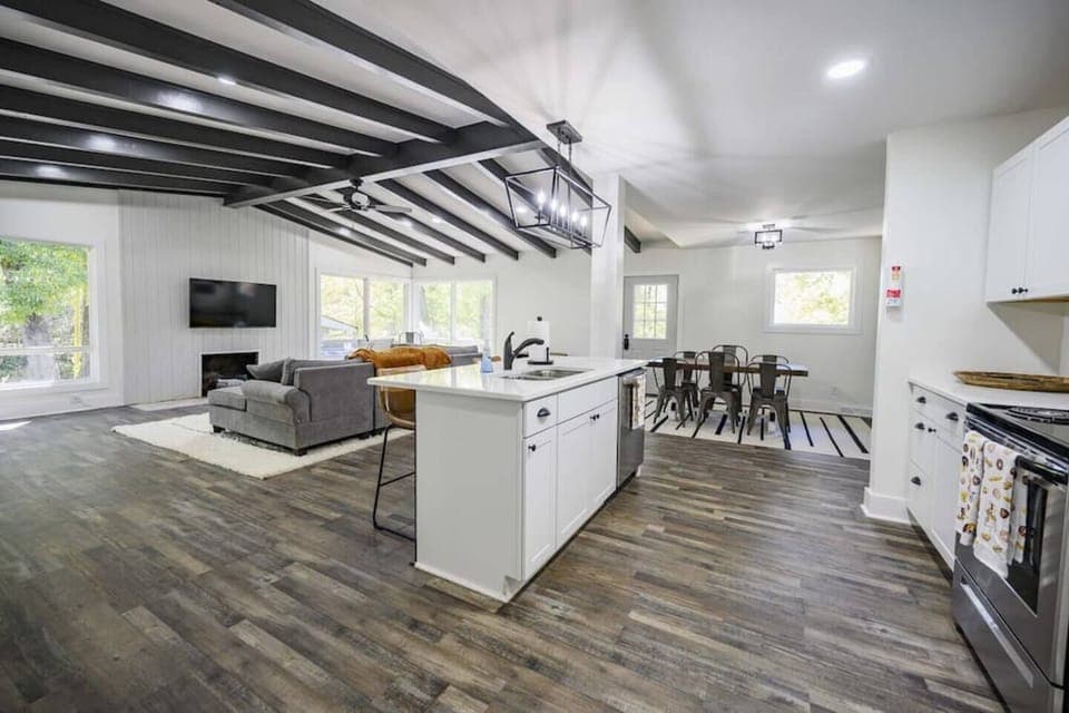 Natural light floods in through large windows, casting a soft glow over the tastefully curated décor that seamlessly blends rustic elements with modern comforts. 