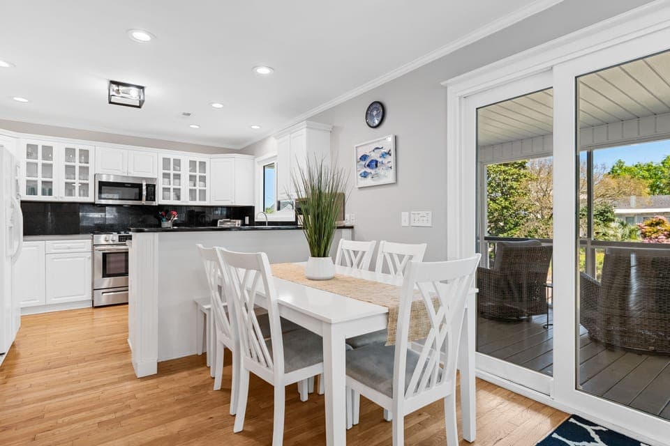 Your open-plan kitchen and dining space flows seamlessly onto a private balcony, perfect for morning coffee or evening meals with garden views.
