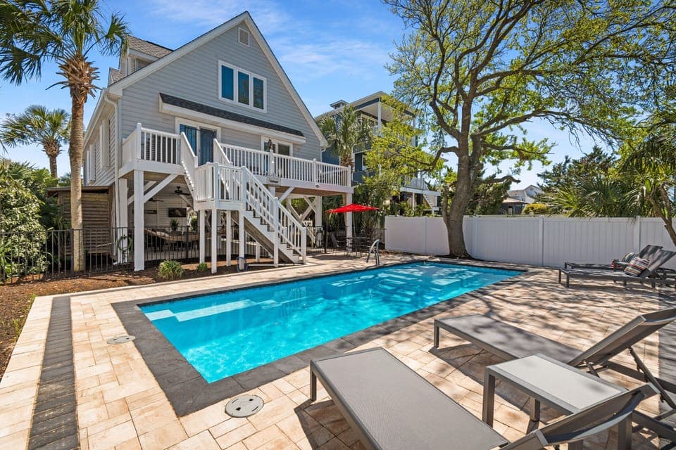 Your private poolside paradise awaits with crystal-clear waters, comfortable loungers, and tropical landscaping creating the perfect Florida retreat.