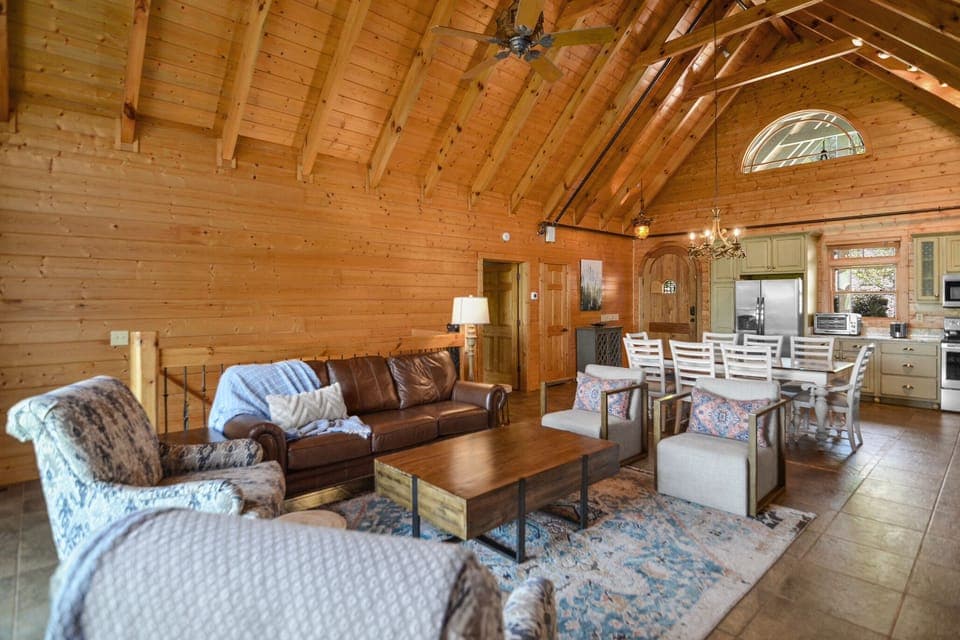Open-concept living and dining area with vaulted wood ceilings