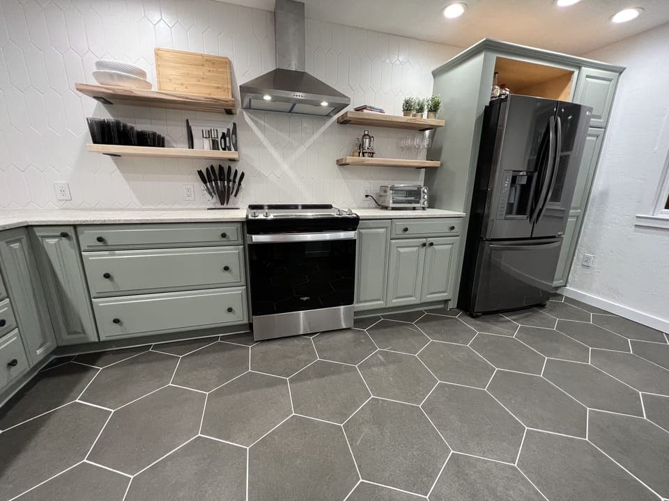 Newly renovated kitchen that opens into dining room with countertop bar seating.