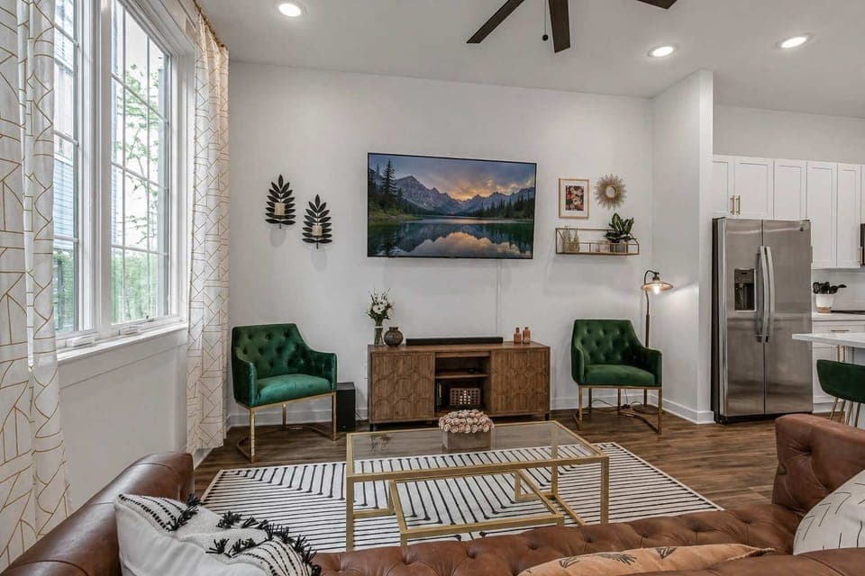 Roomy living area with a mounted Smart TV and comfortable seating for everyone.