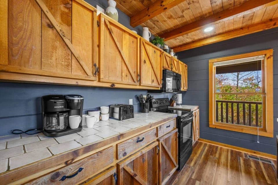 Modern appliances meet rustic cabin woodwork.
