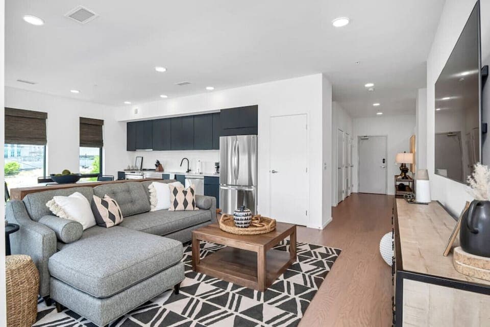 Bright and spacious living room that opens to the kitchen. The couch turns into a sleeper sofa. Custom blackout blinds. Smart TV equipped with YouTube TV for cable.