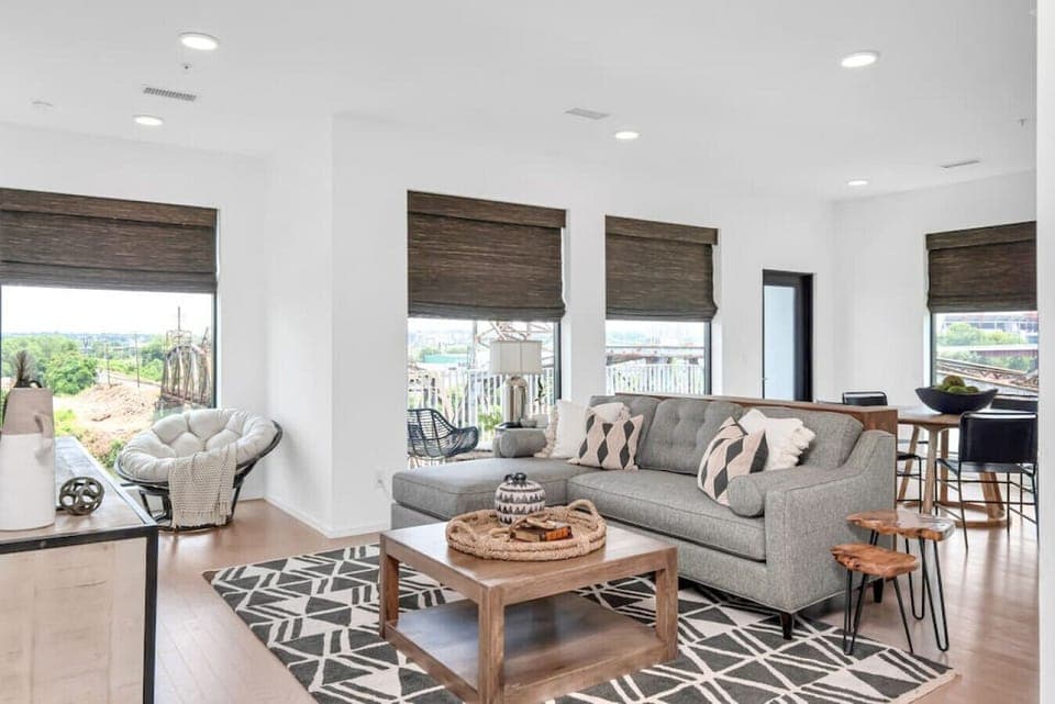 Bright and spacious living room that opens to the kitchen. The couch turns into a sleeper sofa. Custom blackout blinds. Smart TV equipped with YouTube TV for cable.