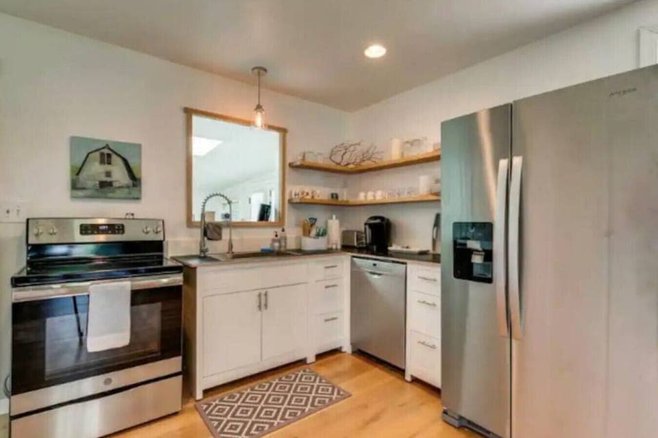 The kitchen, the `window` by the sink looks into the sunroom.