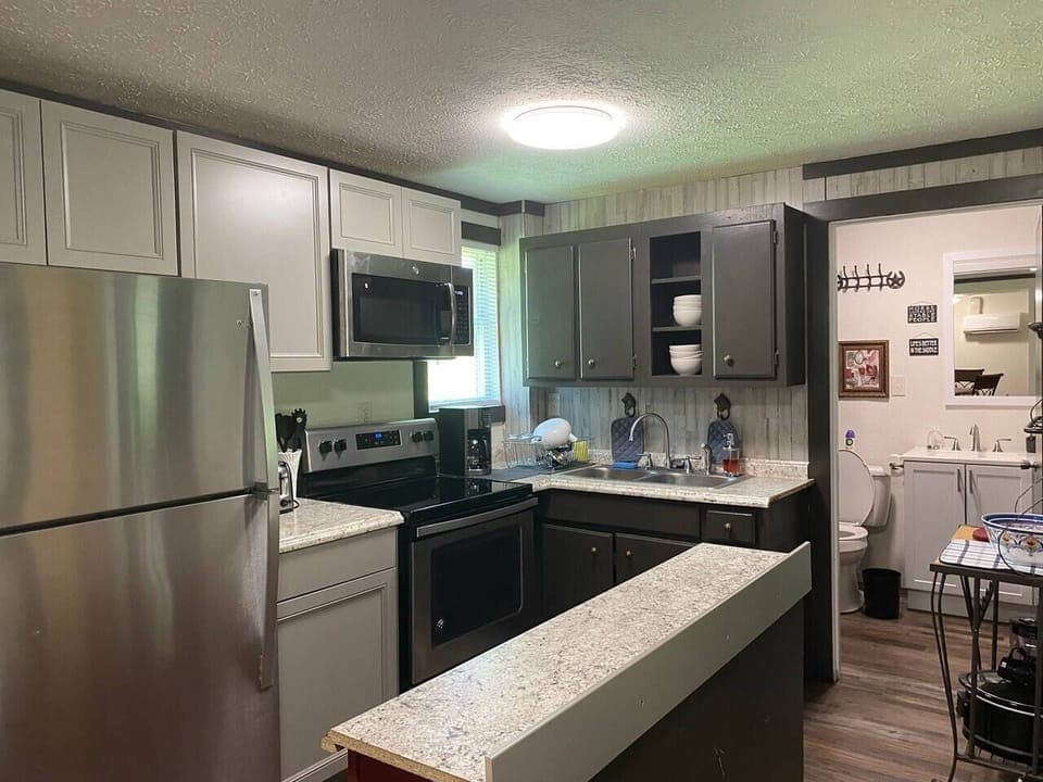 stainless steel refrigerator/freezer, electric stove, microwave, coffeemaker... Kettle, bowls, detergents...  we try to think of everything you might need. 