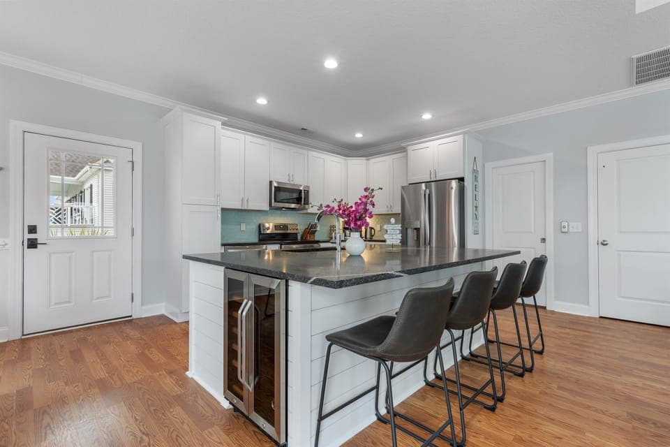 Our newly renovated kitchen including this ovesized island has space for four.  It also features a beverage fridge and ice machine.