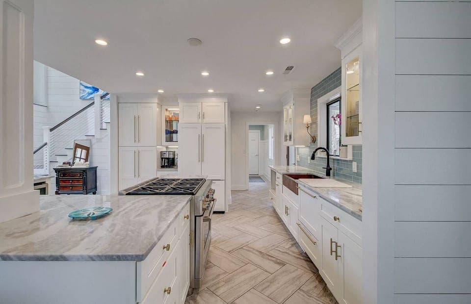 A chef's kitchen with stainless steel appliances and lots of cabinetry for storage.