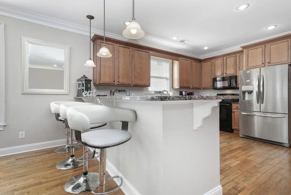 Your fully equipped kitchen features granite countertops, stainless steel appliances, and a breakfast bar where you can sip morning coffee.