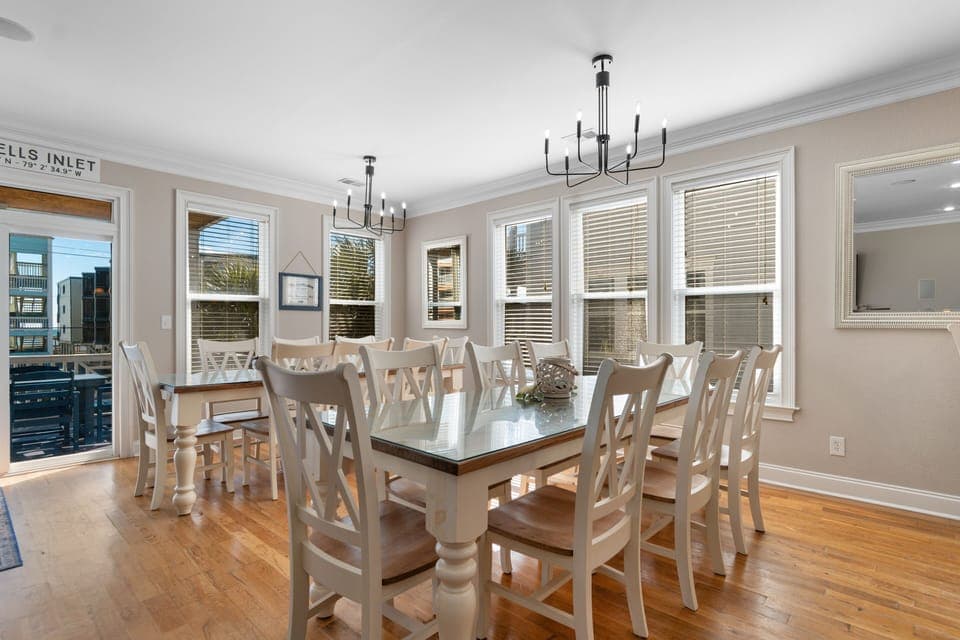 Gather around this spacious dining table where your group can share memorable meals together in natural light streaming through oversized windows.